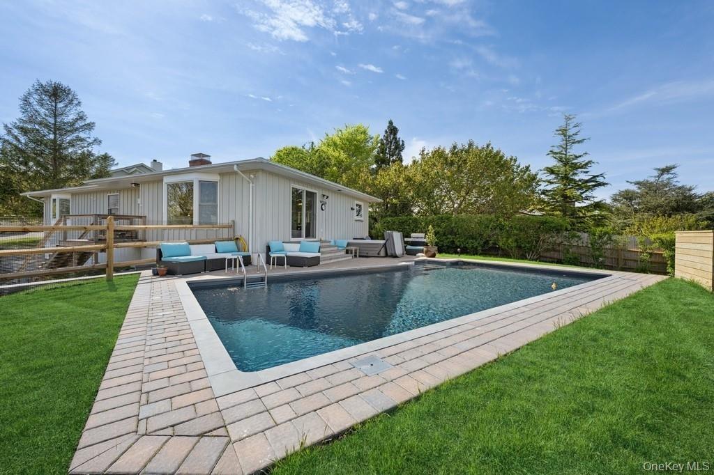 View of swimming pool featuring a fenced backyard, an outdoor living space, and a patio area