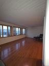 Unfurnished living room featuring hardwood / wood-style floors and wooden ceiling