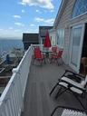 Balcony with a water view and a sunroom