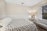 Bedroom featuring a wainscoted wall and a baseboard heating unit