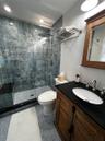 Bathroom with vanity, tile patterned flooring, and a stall shower