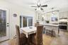 Dining space with light wood-style flooring, healthy amount of natural light, a ceiling fan, and a baseboard radiator