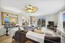 Living area with light wood-style floors, plenty of natural light, and ceiling fan
