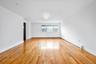 Unfurnished room with a baseboard heating unit and light wood-style floors