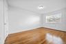 Unfurnished room featuring light wood-type flooring and a baseboard radiator