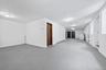 Basement featuring baseboard heating and washer / dryer