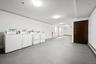 Basement with washer and clothes dryer and a baseboard radiator