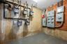 Utility room with electric meter and a garage