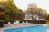 View of swimming pool featuring a patio area and view of scattered trees