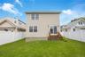 Back of house with a fenced backyard