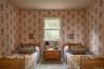 Bedroom featuring wallpapered walls