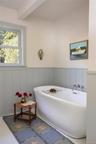 Bathroom with a soaking tub and wainscoting
