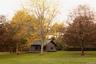View of grassy yard with a wooden deck