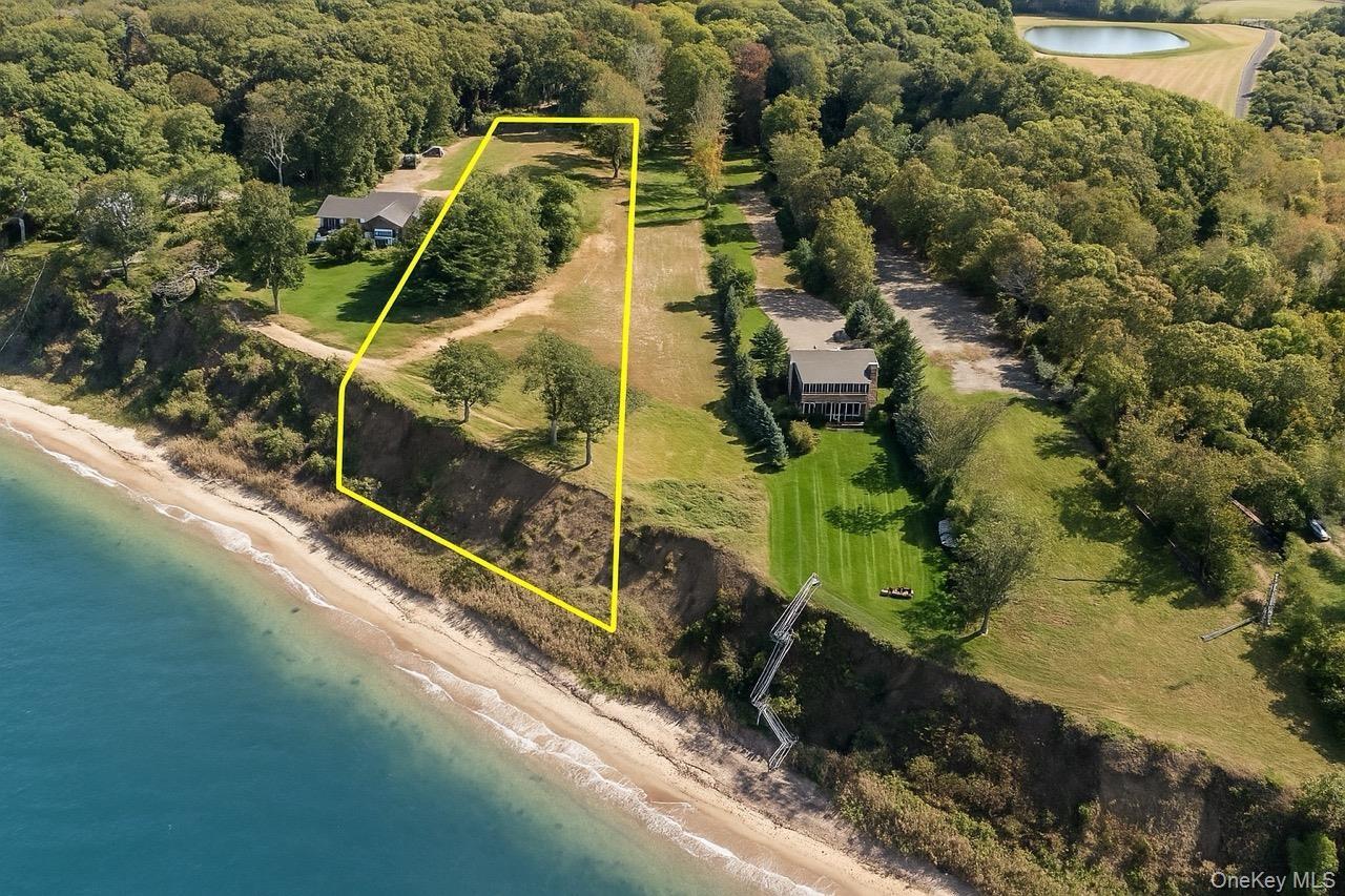 View of property location with a nearby body of water and property parcel outlined