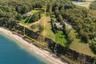 View of property location with a nearby body of water and property parcel outlined