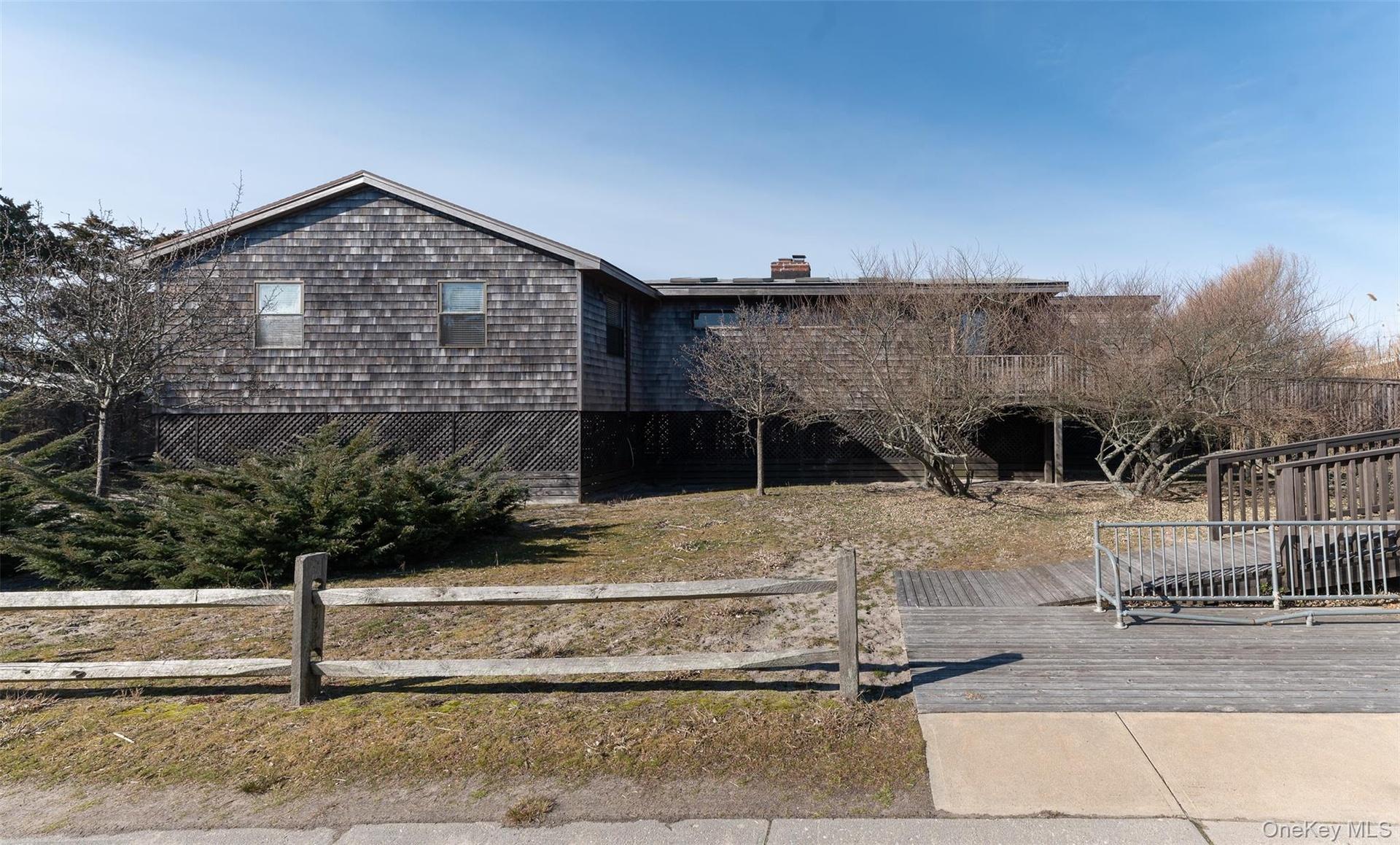 View of front of property with a deck and a chimney
