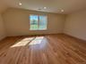 Additional living space with recessed lighting and light wood-type flooring