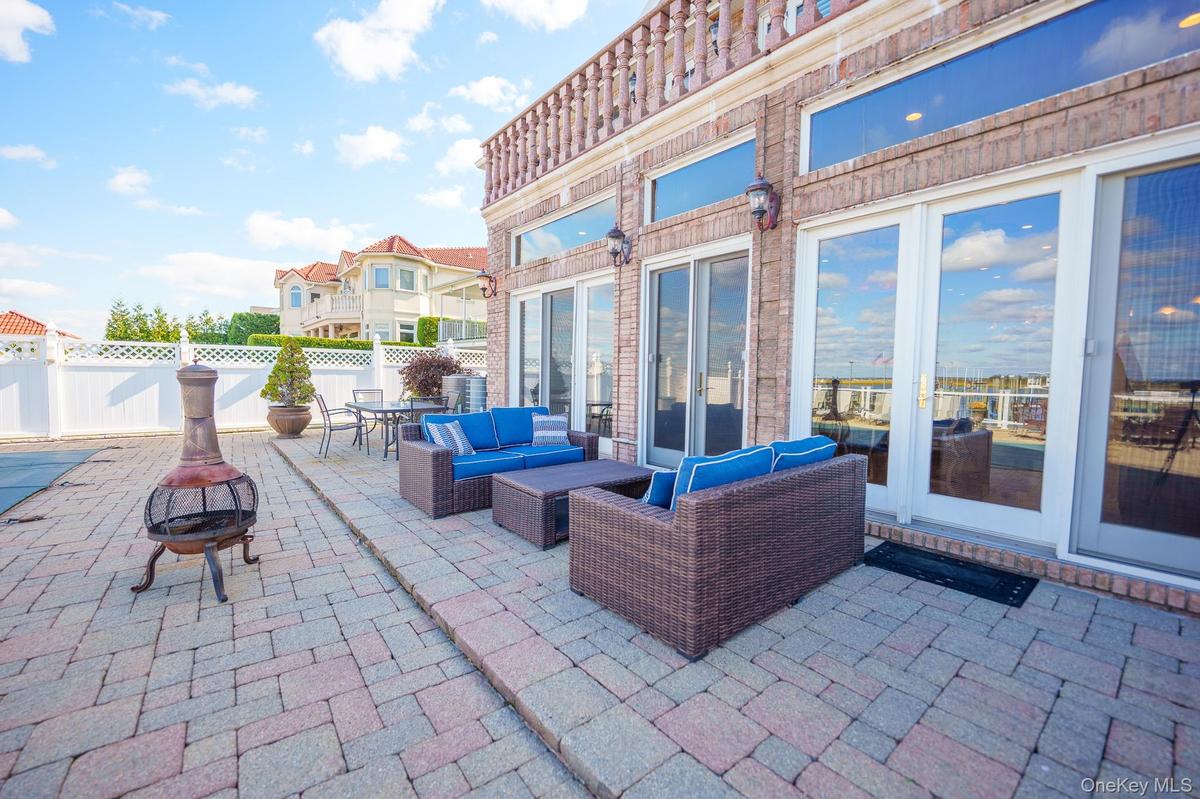 Fenced backyard with a patio area, an outdoor living space with a fire pit, and outdoor dining space
