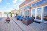 Fenced backyard with a patio area, an outdoor living space with a fire pit, and outdoor dining space