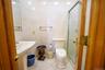Bathroom with tile patterned flooring, tile walls, and a shower stall