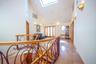 Hallway featuring a skylight, high vaulted ceiling, an upstairs landing, and radiator