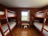 Bedroom featuring wood walls and wood-type flooring