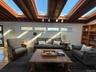 Living area with beamed ceiling, wood finished floors, and a skylight