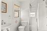 Full bathroom with a stall shower and tile walls
