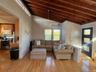 Living room with light wood-style floors and wooden walls