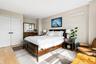 Bedroom featuring light wood finished floors and a closet