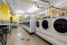 Shared laundry room featuring separate washer and dryer