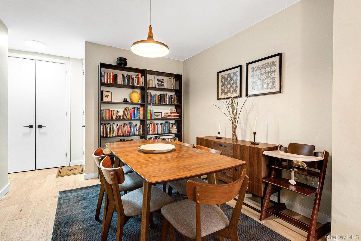 Dining room featuring light wood-style flooring and baseboards
