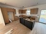 Kitchen featuring light wood-type flooring, brown cabinets, and a center island