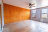 Unfurnished room with ceiling fan, radiator heating unit, and light wood-type flooring