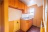 Kitchen with dark parquet flooring, decorative backsplash, and sink