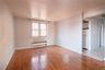 Unfurnished room with hardwood / wood-style flooring and radiator