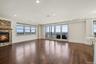 Unfurnished living room with a fireplace, dark wood-style floors, and recessed lighting