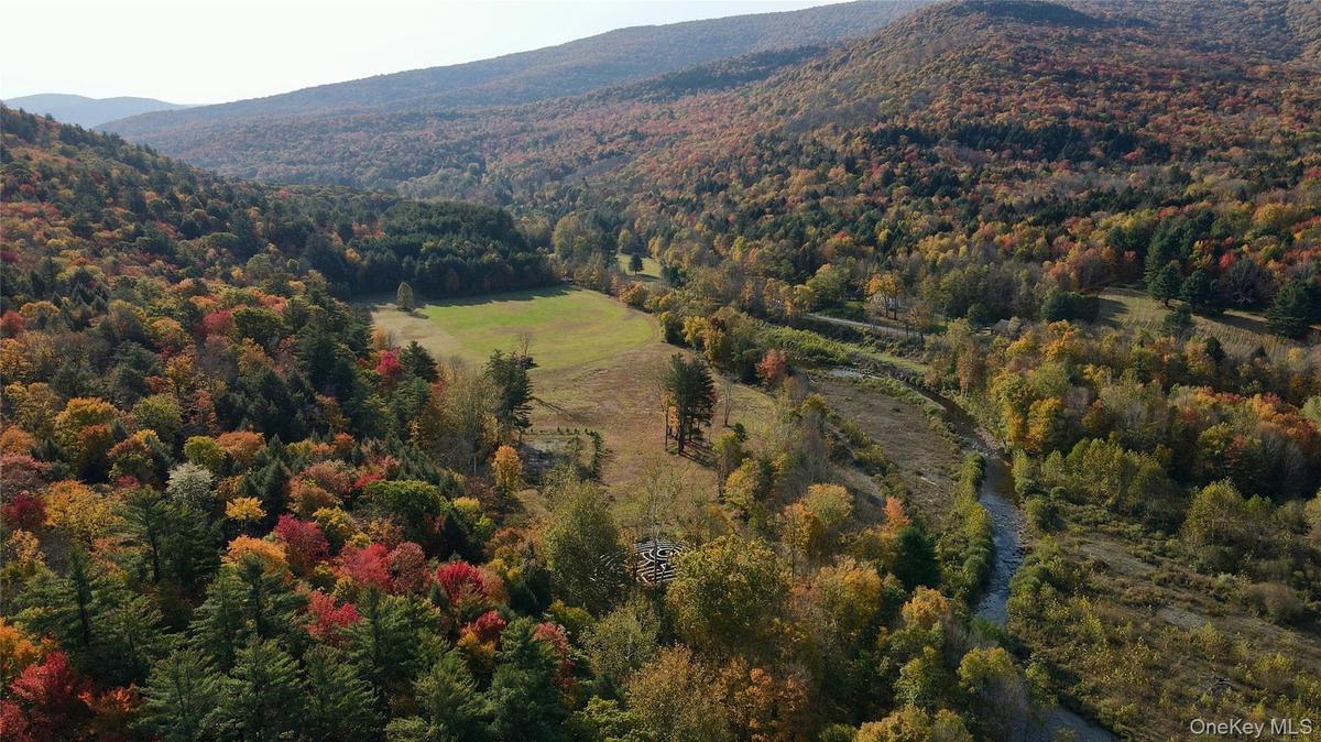 Aerial view of property and surrounding area with mountains