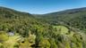 Drone / aerial view of stick and ball polo field and a mountain backdrop