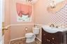 Bathroom featuring an inviting chandelier, vanity, and toilet