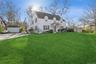 View of front of house featuring an outbuilding, a front lawn, and a garage