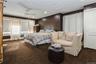 Carpeted bedroom with ornamental molding and ceiling fan