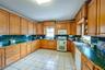 Kitchen featuring sink, white appliances, and decorative backsplash