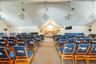 Carpeted home theater with high vaulted ceiling