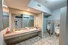Bathroom featuring tile walls, sink, and tile patterned flooring