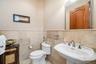 Bathroom with wainscoting and tile walls