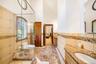 Bathroom featuring tile walls, vanity, a towering ceiling, marble tiled flooring, and a stall shower