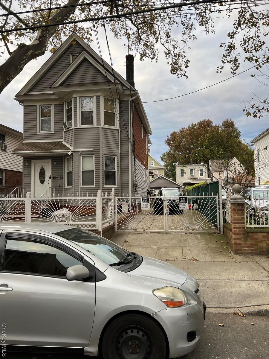 View of front of home featuring a fenced front yard, a gate, and a chimney