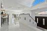 Tiled entrance foyer with stairway, crown molding, and recessed lighting