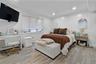 Bedroom featuring crown molding, a baseboard heating unit, light wood-type flooring, and recessed lighting